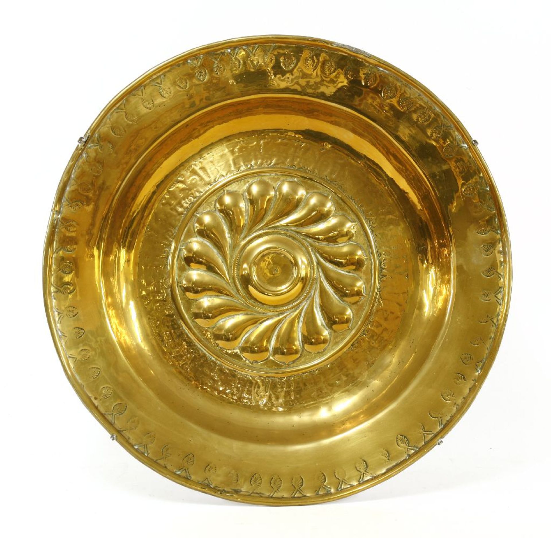 A brass alms dish,18th century, inscription worn, 38cm diameter Provenance: The property of a