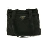 A Prada black canvas shopper handbag, exterior zip pocket with maker's signature enamel triangular