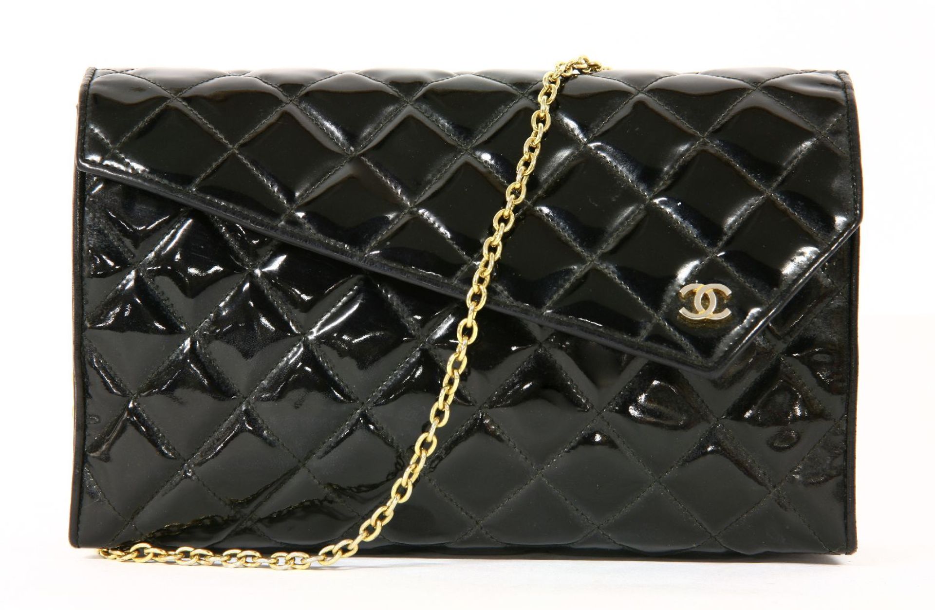 A vintage Chanel black patent quilted clutch handbag,with silver-tone double 'C' monogram to a