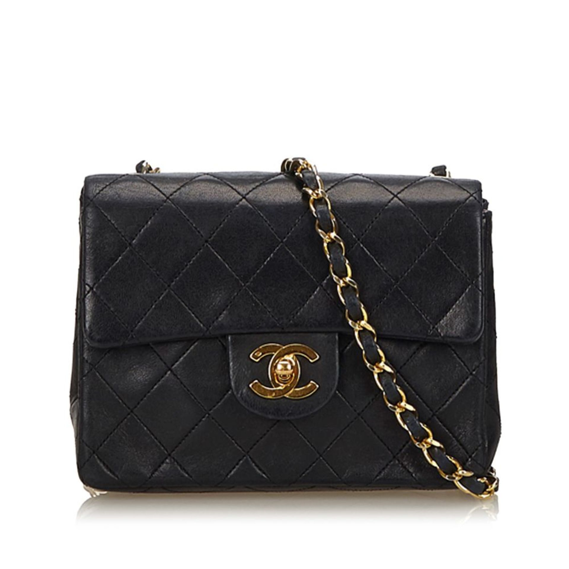 A Chanel mini classic flap handbag,features a quilted leather body, exterior back slip pocket, a