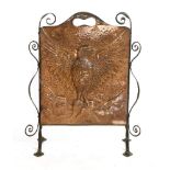 An Arts and Crafts copper fire screen,embossed with an eagle with its wings spread, on a wrought