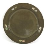 A Tudric pewter plate,designed by Archibald Knox for Liberty & Co., the border mounted with