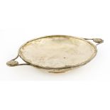 A silver dish,A E Jones, Birmingham, 1919, of circular form with twin handles mounted with a rose
