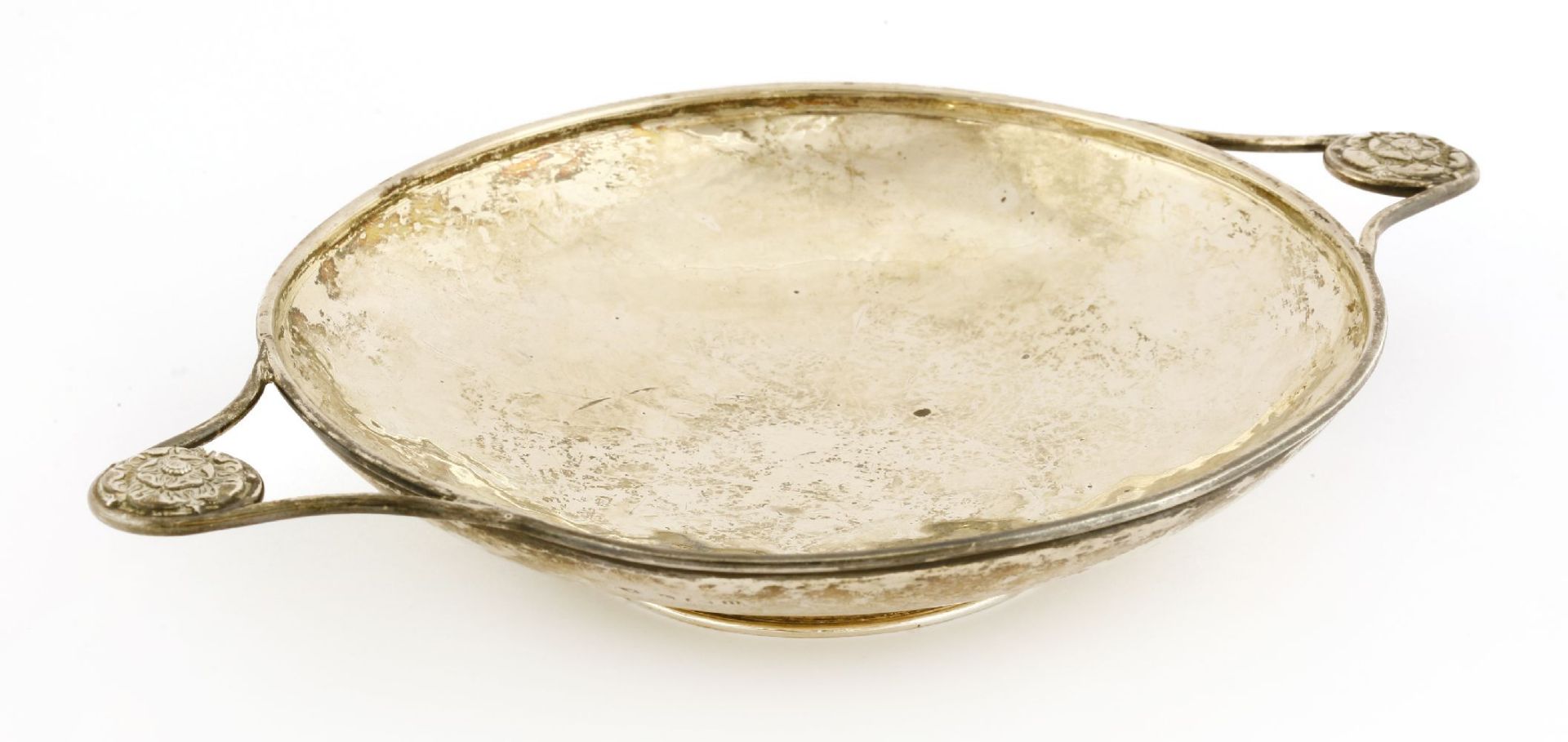 A silver dish,A E Jones, Birmingham, 1919, of circular form with twin handles mounted with a rose