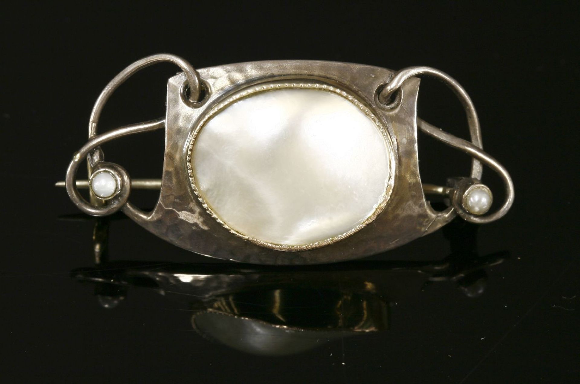 A Murrle Bennett & Co. silver and blister pearl brooch, a central blister pearl milligrain set to a