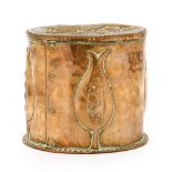 A John Pearson pot and cover,embossed with stylised flower heads, the cover with a lion rampant,
