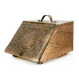 An Arts and Crafts copper-mounted coal scuttle,attributed to John Pearson, with a strap handle,
