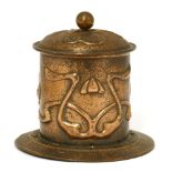 An Arts and Crafts copper tobacco pot and cover, the 'scaled' ground with stylised motifs, with a