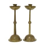 A pair of WMF metal candlesticks, each on a loaded plinth, stamped marks and numbered 133, 27cm high