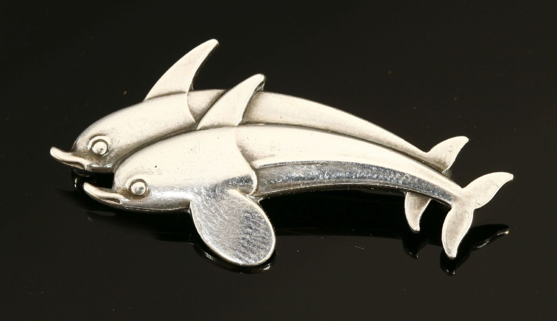 A Georg Jensen sterling silver dolphin brooch,designed by Arno Malinowski, stamped and numbered