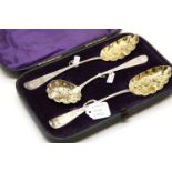 A cased pair of Victorian silver berry spoons, together with a silver sifter spoon