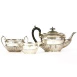 A silver three piece tea set, to include teapot, sugar bowl and milk jug, by Walker & Hall,