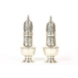 A pair of silver George II sugar casters, the plain baluster form engraved with coat of arms, the