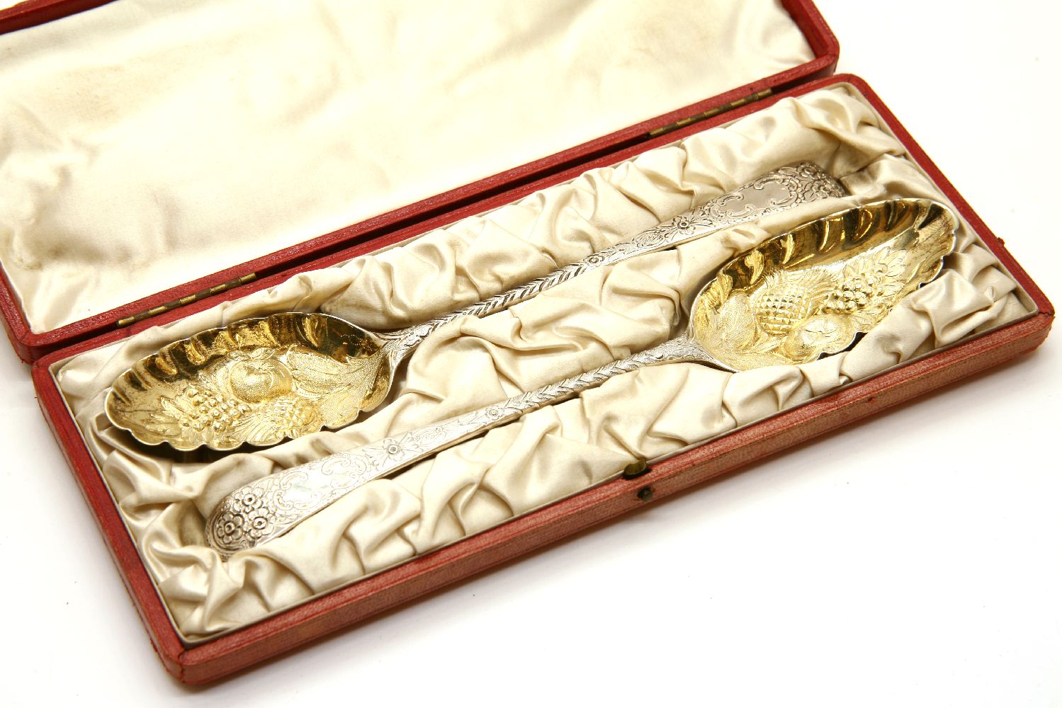 A cased pair of Victorian silver berry spoons