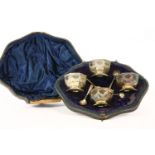 A set of four silver octagonal salts, with matching spoons, in a fitted case, damaged