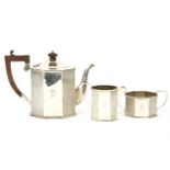 A silver octagonal three piece tea set to, include a teapot with hardwood handle and finial by