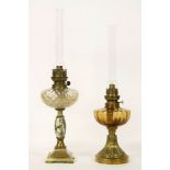 Two French oil lamps, with glass reservoirs and chimneys, 59cm high