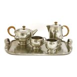 A Tudric pewter four-piece tea set, stamped marks and numbered '0216', teapot 13.5cm high, and a