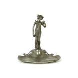 A pewter Art Nouveau dish, mounted with a lady reading a letter, stamped marks, 18.5cm