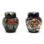 A Moorcroft 'Pointsettia' ginger jar and cover, 2002, 11cm high, and a Pansy ginger jar and cover,