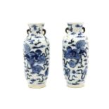 A pair of Canton blue and white vases, late 19th century, decorated with dogs of Fo, and flowers,