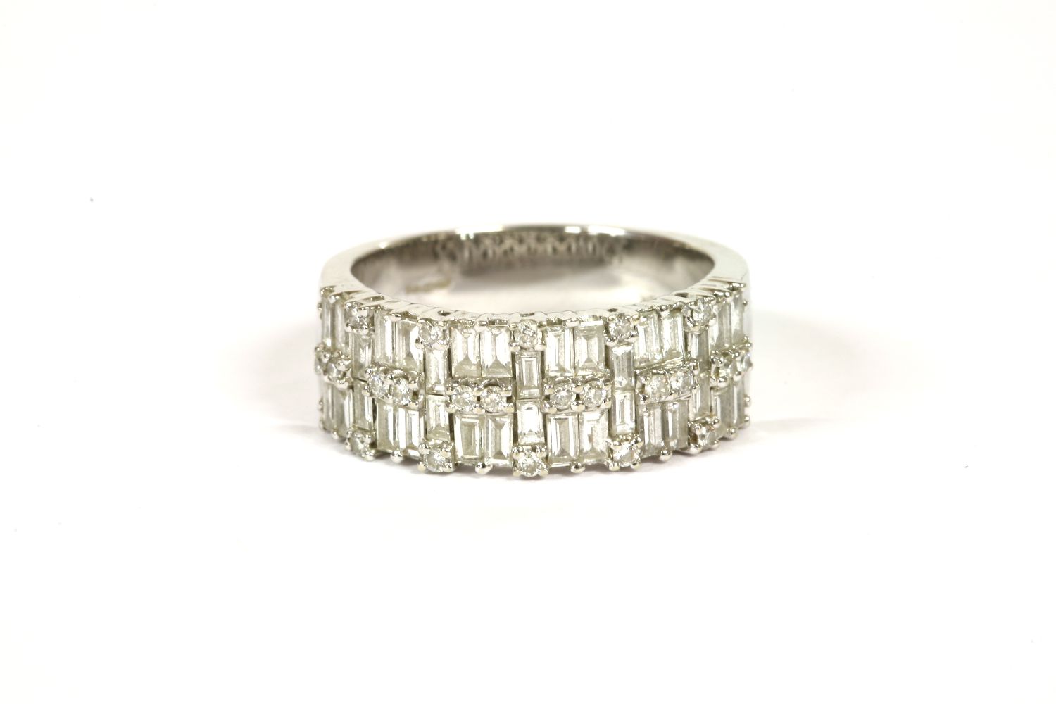 An 18ct white gold two row diamond band ring, set with baguette cut and brilliant cut diamonds, claw