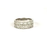 An 18ct white gold two row diamond band ring, set with baguette cut and brilliant cut diamonds, claw