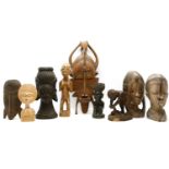 A collection of wooden African sculptures, to include a fertility figure and masks