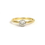 A gold single stone diamond ring, a brilliant cut diamond claw set to chenier shoulders and a