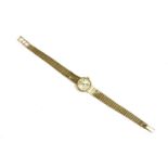 A ladies 9ct gold Omega mechanical bracelet watch, silvered dial, raised baton numerals and an