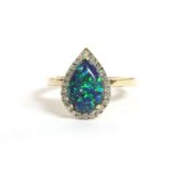 A gold pear shaped synthetic opal and diamond cluster ring, to a plain polished shank, marked 10k,
