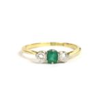 A gold emerald and diamond three stone ring, marked 18ct and PT, size N, 2.26g
