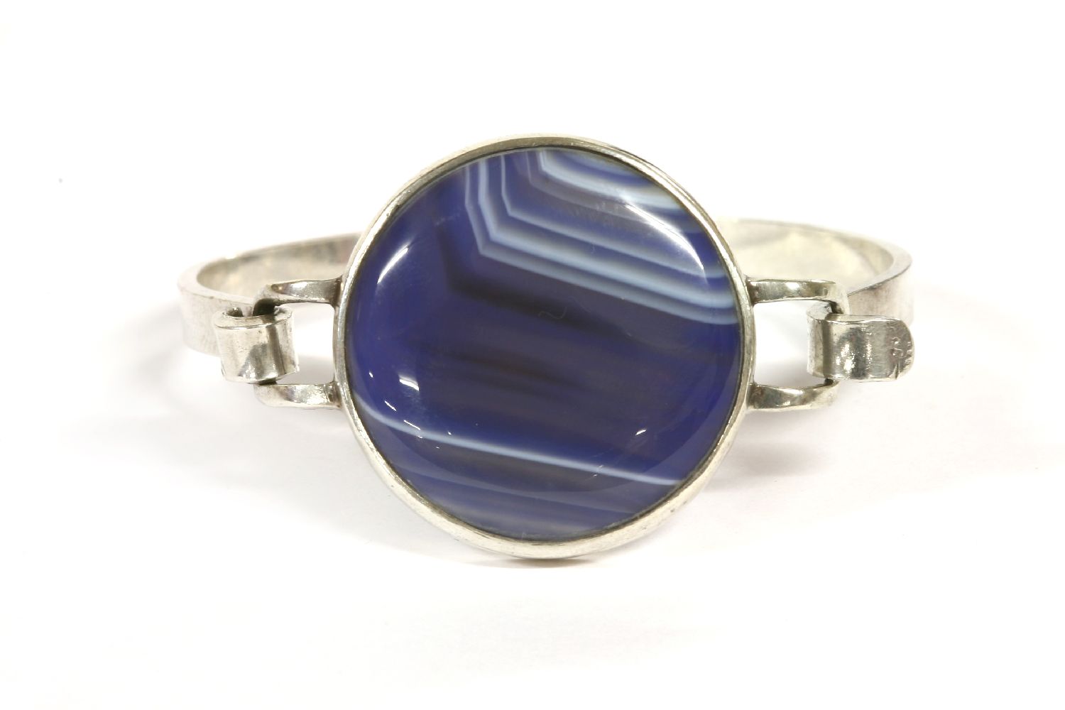 A sterling silver agate bangle, by Daedalus Ltd, c.1970, with a circular banded agate plaque, rub