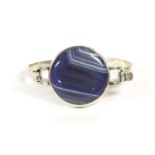 A sterling silver agate bangle, by Daedalus Ltd, c.1970, with a circular banded agate plaque, rub