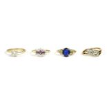 A gold single stone blue synthetic ring, oval cut to textured white shoulders and a plain polished