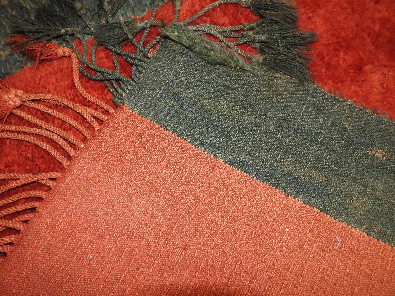 A Northern Afghanistan hand knotted woollen rug, the bold central red field flanked by blue stripes, - Image 2 of 2