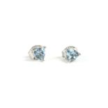 A pair of white gold single stone aquamarine earrings, trillion shaped aquamarines, claw set to post