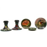 A pair of Moorcroft Hibiscus candlesticks, 8.5cm high, a Hibiscus dish, 9.5cm, another 8cm diameter,