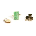 A gold carved jade plaque ring, marked 9ct, claw set, 2.84g, and a 9ct gold hardstone shamrock