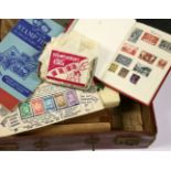 A collection of stamps in a brown case, to include a red album, loose stamps, envelopes, tins, a set