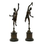 A pair of 19th century classical bronze figures, on cylindrical plinth bases, 43cm high