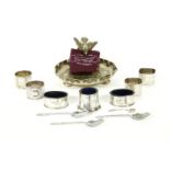 A three piece silver and blue glass cruet set, together with four silver napkin rings, three