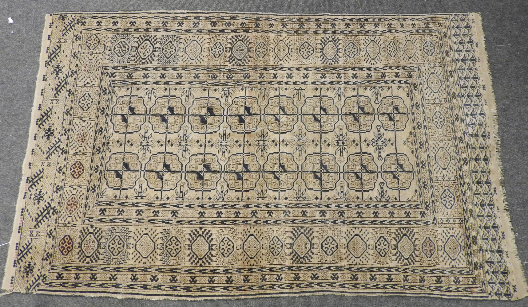 An Eastern rug, with geometric motifs on a pale brown field, 230 x 142cm