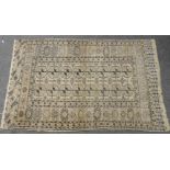 An Eastern rug, with geometric motifs on a pale brown field, 230 x 142cm