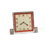 A cased Art Deco chrome and red enamel Smith's mechanical eight day Boudoir clock, silvered dial,