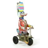 A Japanese tinplate toy, in the form of a duck, wearing propeller hat and riding a tricycle, 22cm