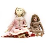 A Victorian bisque head doll, and a wooden doll