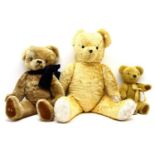 A Merry Thought blonde plush teddy bear, with moveable limbs, 36cm high, together with two larger