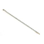 A gold topaz and diamond line bracelet, a series of oval cut topaz between pairs of rose cut