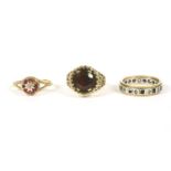 A 9ct gold single stone garnet ring, pierced head and plain polished shank, 3.42g, a 9ct gold two